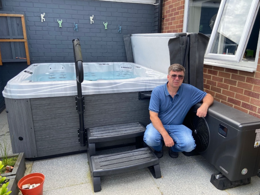 man near hot tub and heatpump