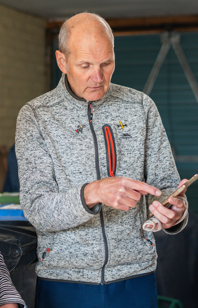 man pointing at phone